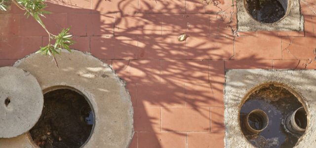 Birds eye view of open drains in cocnrete floor