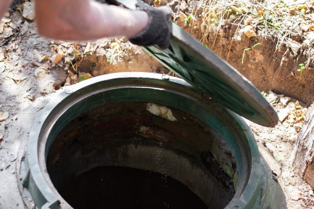 A opening a septic tank hatch