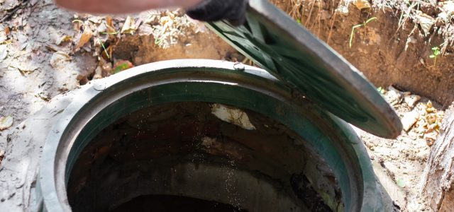 A opening a septic tank hatch