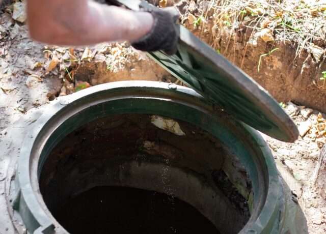 A opening a septic tank hatch