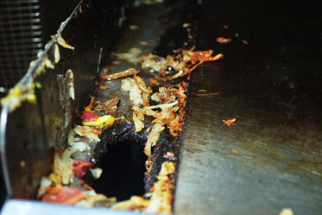 A close up of a grease trap at a restaurant.