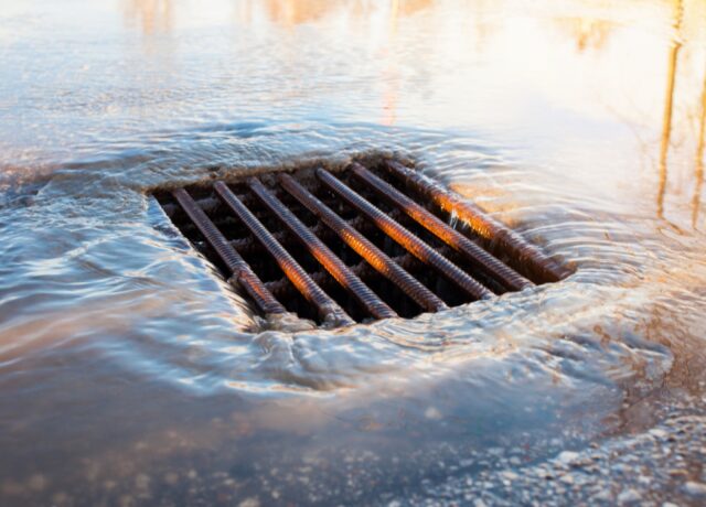 rain water entering a street sewer grate